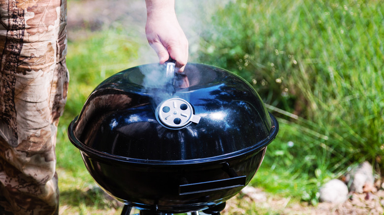 Holding the lid on a charcoal grill