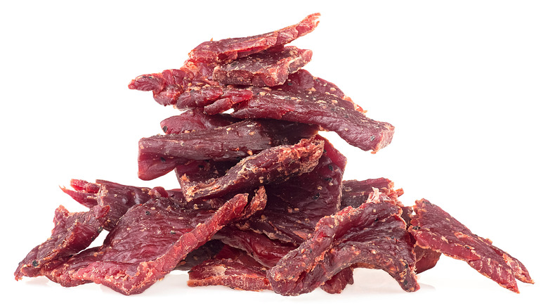 A pile of beef jerky against a white background
