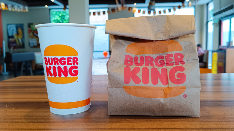 Burger King bag and drink on table