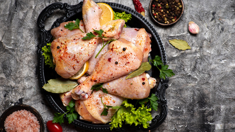Raw chicken legs marinating