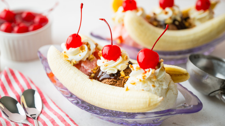 Banana splits with cherries and whipped cream