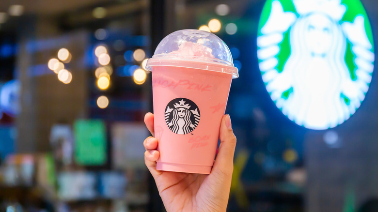 Hand holding up a Starbucks Frappuccino