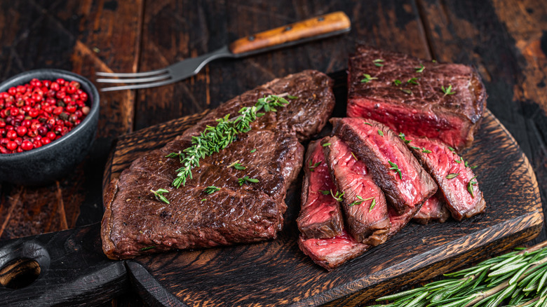 Sliced beef skirt steak on a wooden board