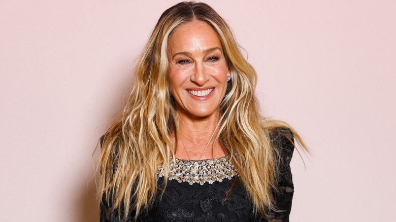 Sarah Jessica Parker poses against pink background