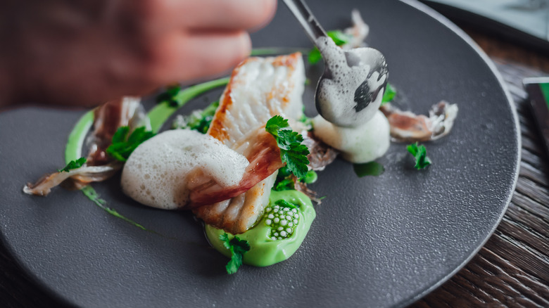 Beautiful fish dish being presented on plate