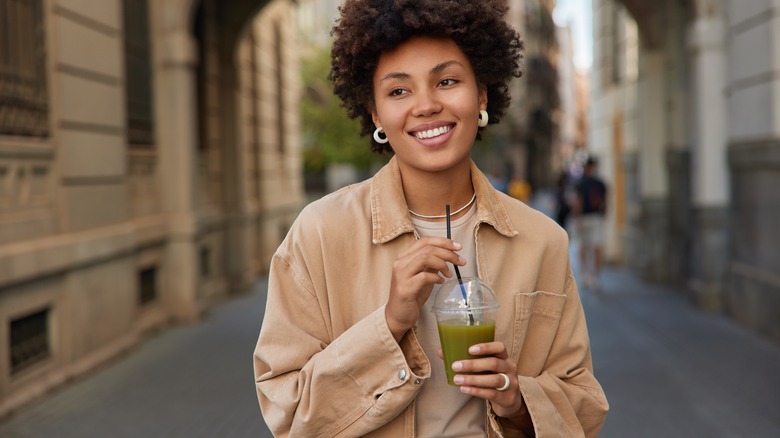 Woman with green smoothie