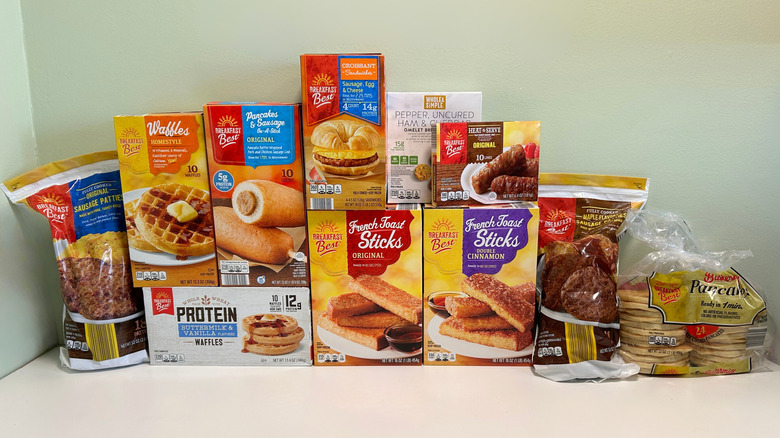 Variety of Aldi's frozen breakfast items stacked on a table