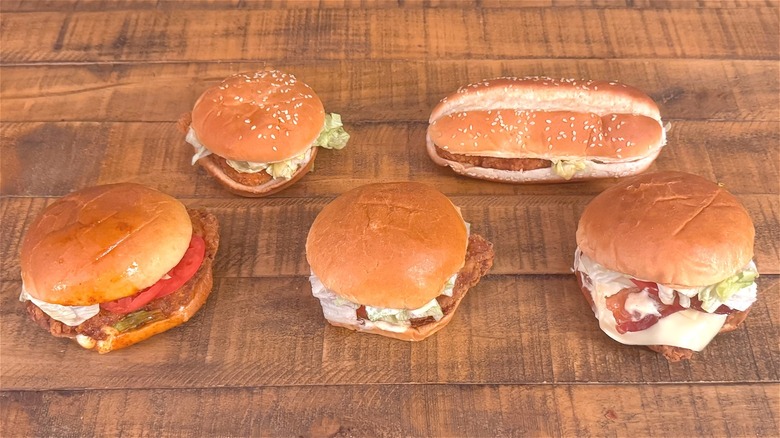 Assorted unwrapped Burger King chicken sandwiches on table