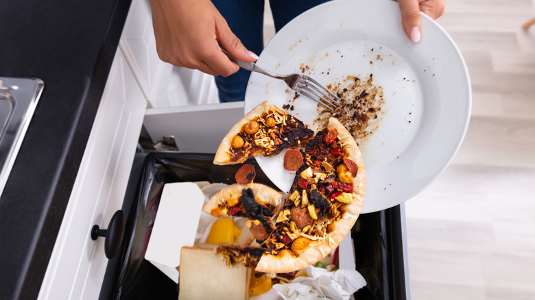 Person throwing away leftover food