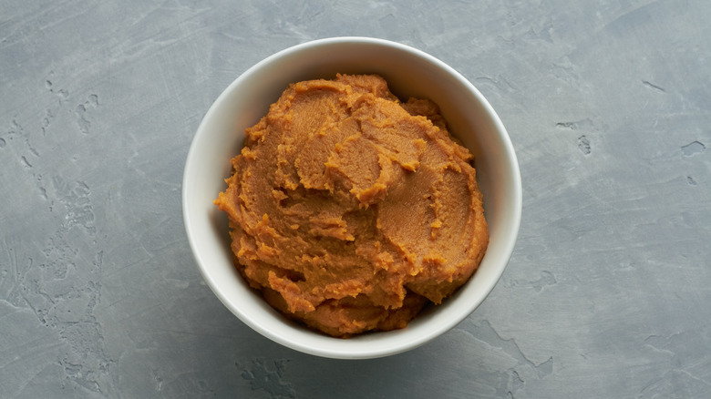 Miso paste in a bowl on gray surface