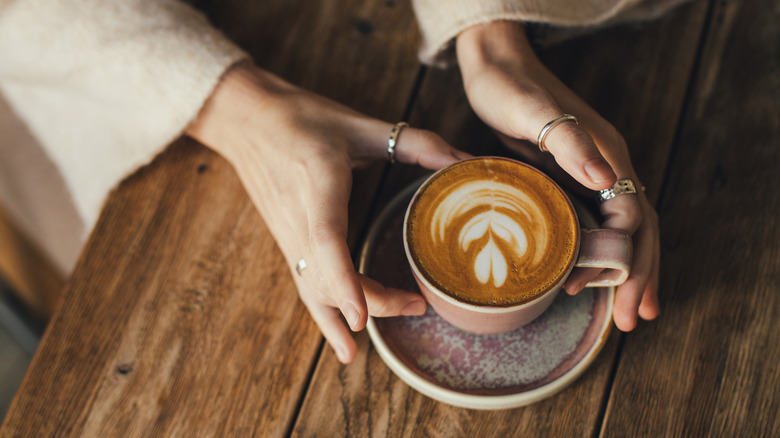 Hands holding latte