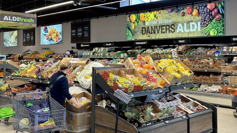 Interior of an Aldi store with customer shopping.