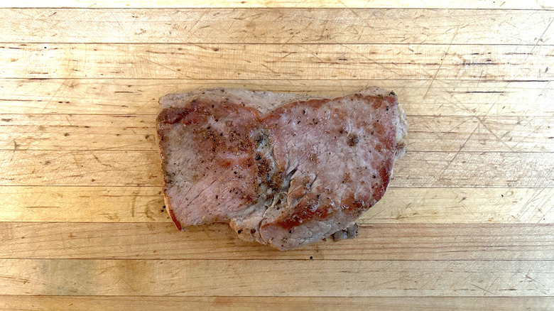 Seared sirloin steak on a wooden cutting board