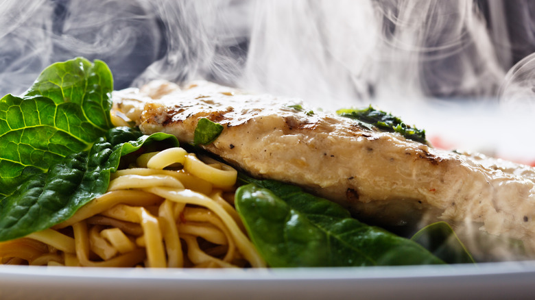 Steaming meat topped with basil pesto