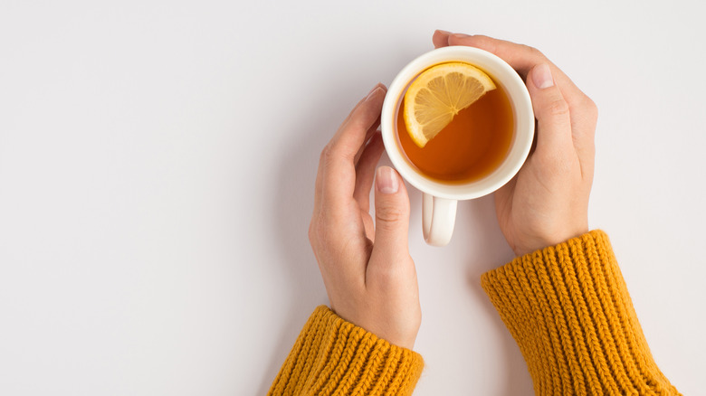 hands holding cup of tea