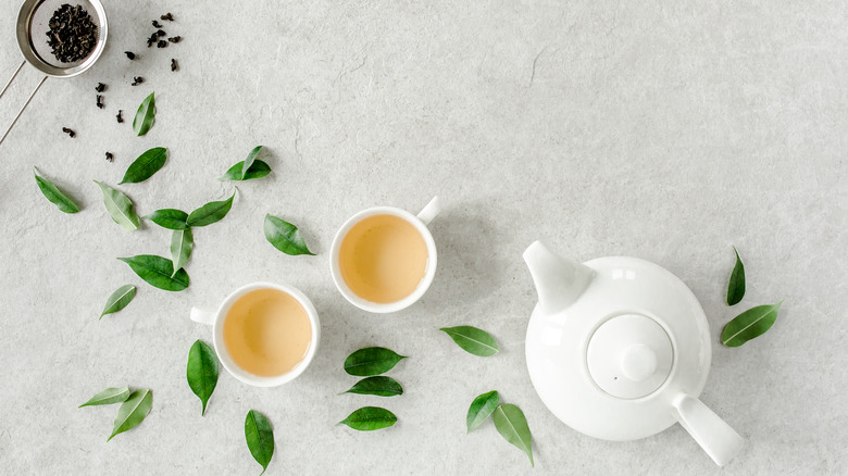tea pot and leaves, two cups