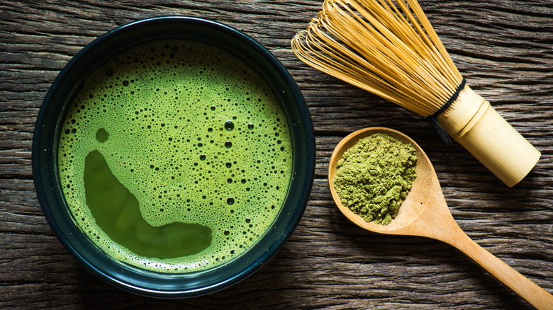 Green tea with spoon and whisk