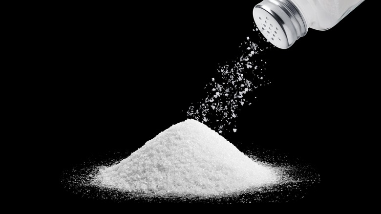 Salt shaker pouring salt