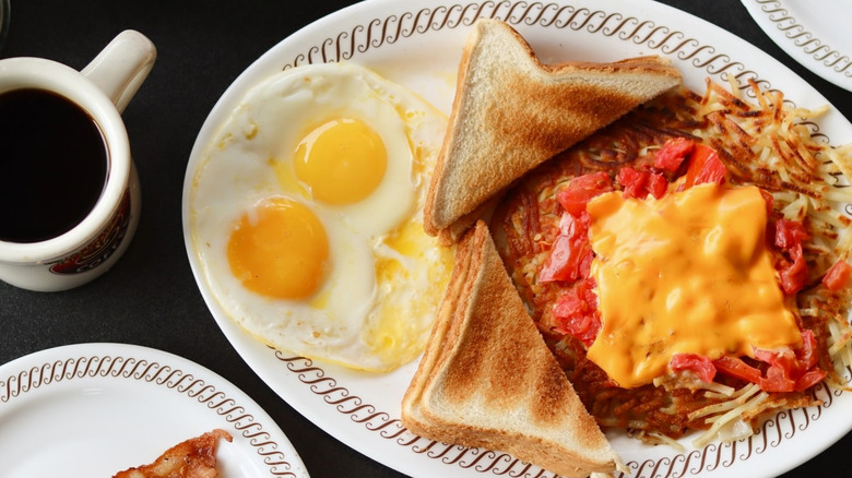 Waffle House breakfast with eggs, hash browns, toast, cheese and tomatoes