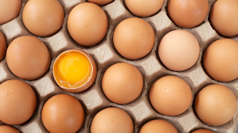 eggs in a carton with one cracked
