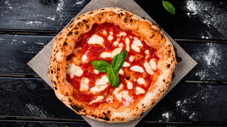 Cooked pizza on pizza stone 