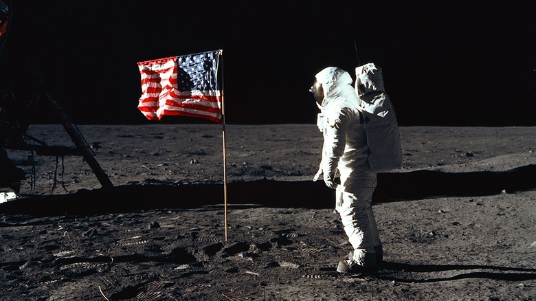 Astronaut planting flag on moon