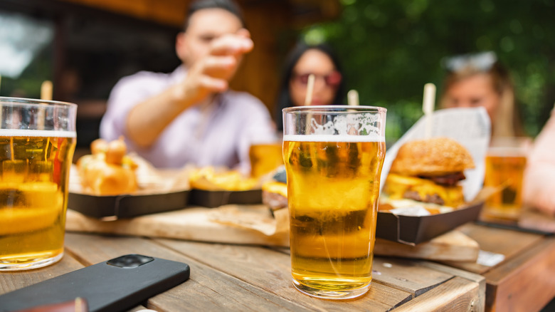 cups of beer on table at barbecue