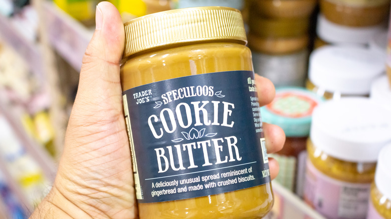 Hand holding Speculoos cookie butter in Trader Joe's