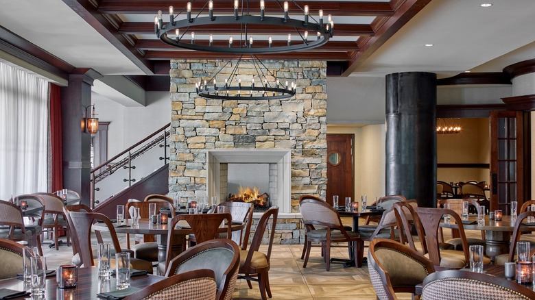 dining room with tables in front of fireplace