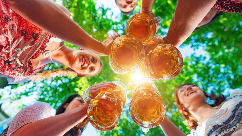 people toasting beer glasses 