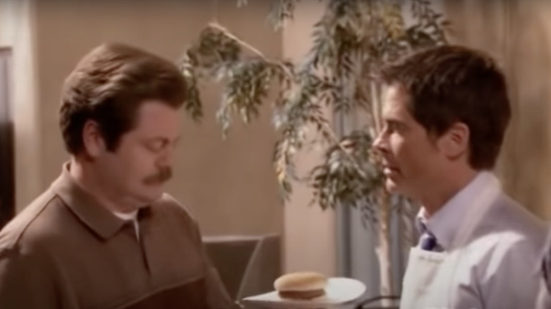 Ron Swanson holding a burger