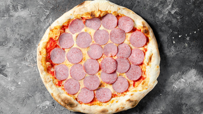 Frozen pepperoni pizza on granite counter