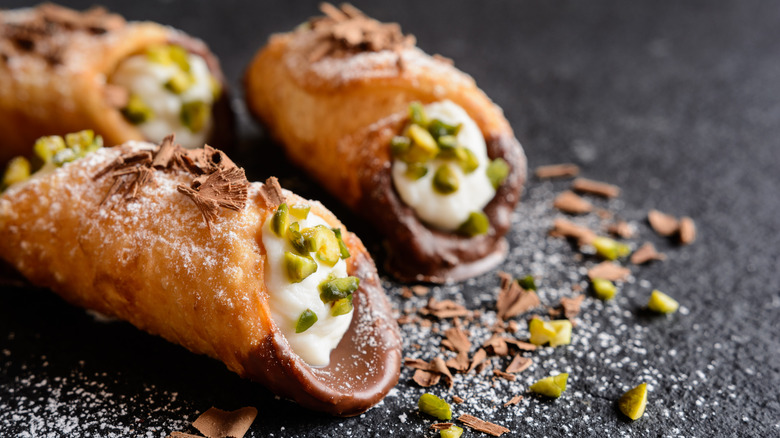 Two cannoli on slate