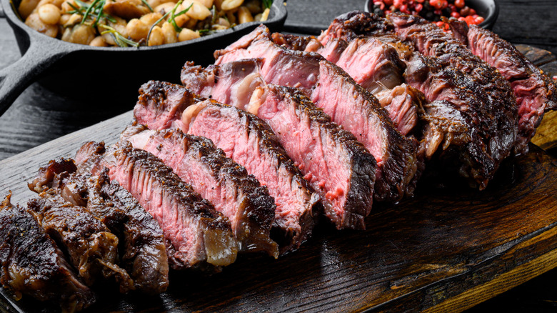 grilled meat on wooden plank