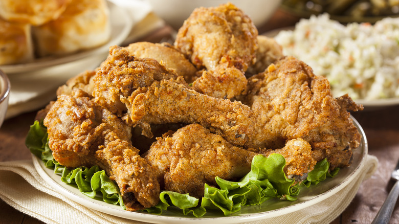 seasoned fried chicken on lettuce on a plate