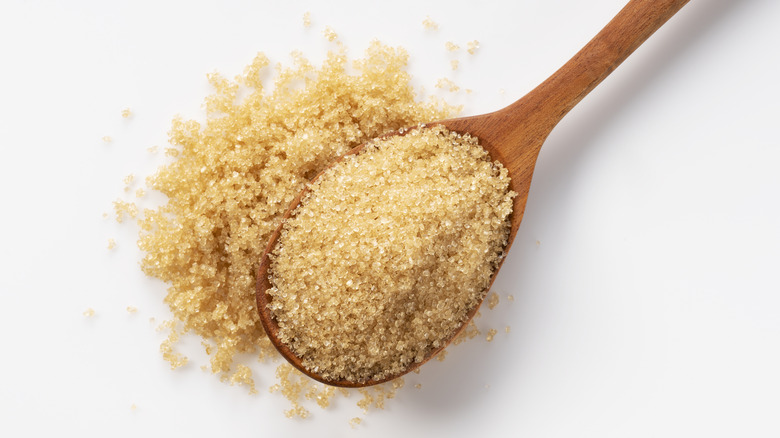 Wooden spoon with brown sugar 