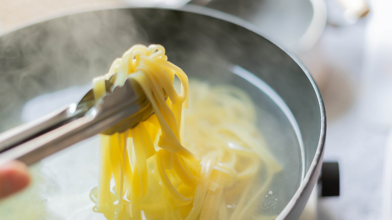 Removing linguine from cooking water