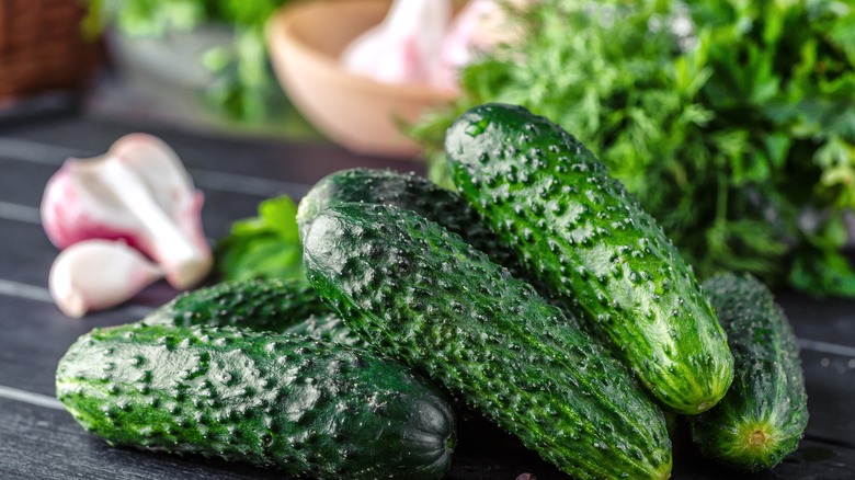 Cucumbers on dark wood surface