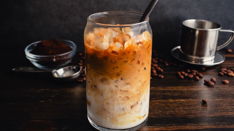Vietnamese iced coffee with phin filter and grounds