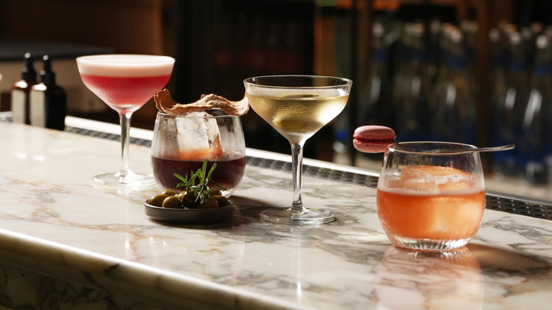 An assortment of colorful cocktails on a bar