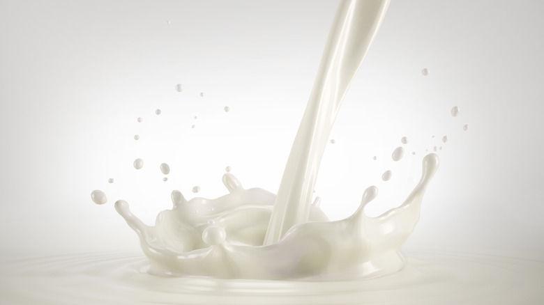 Milk being poured and splashing up