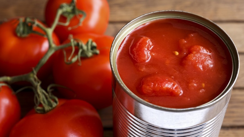 tomatoes next to tomato can