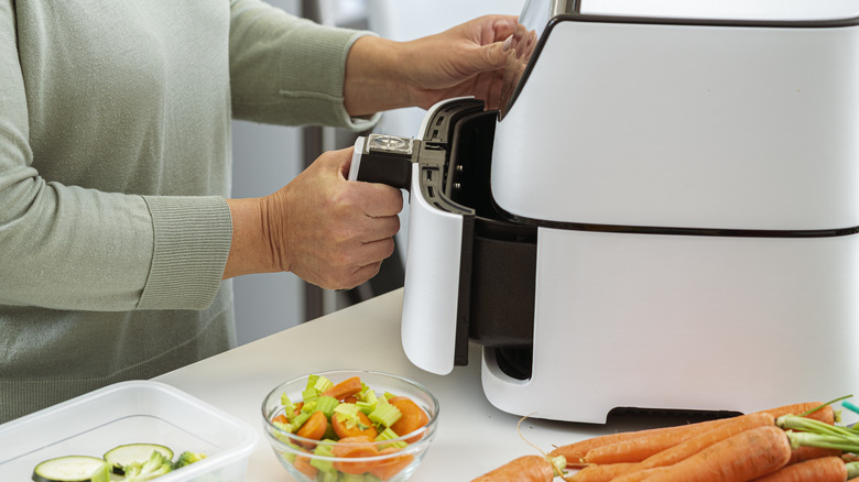 Person cooking in an air fryer