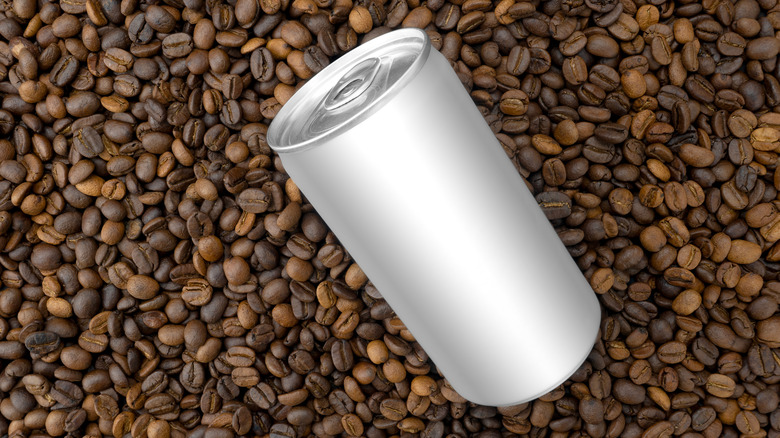 An aluminum can sits on coffee beans