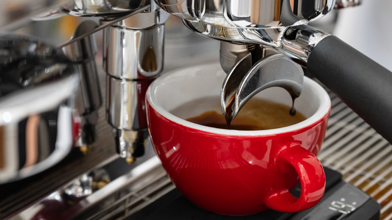 Espresso machine pouring coffee into a cup