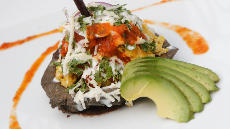 Mexican food dish featuring avocado, corn, and a gastrique