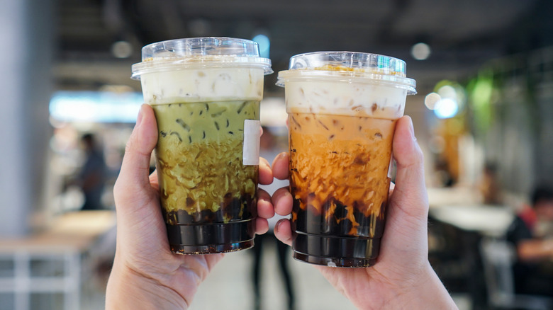 Two friends holding boba