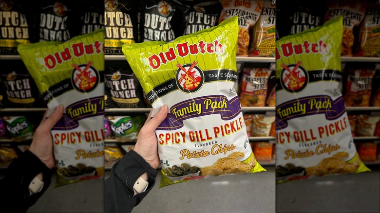 hand holding Old Dutch chips in grocery aisle