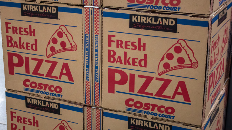 Stacks of Costco pizza boxes