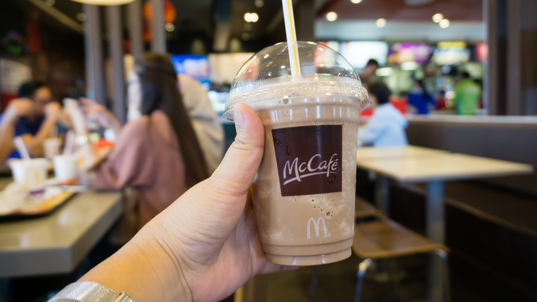 Customer holding McCafe beverage
